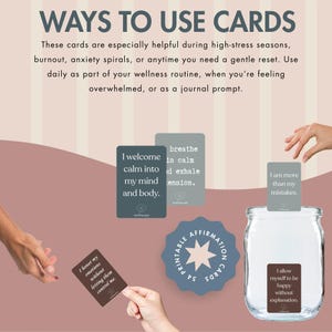 May include: Image of affirmation cards with text. The cards are in various shades of gray and brown, with phrases like "I welcome calm into my mind and body." A jar with a label that says "I allow myself to be happy without explanation" is also present.