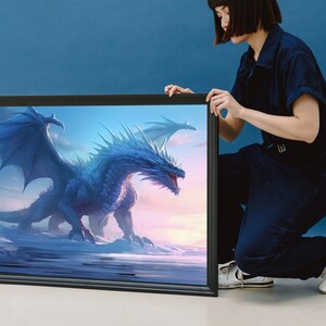 May include: A framed canvas print featuring a blue dragon with wings spread wide, set against a cloudy sky with a pink and orange sunset. The dragon is in the foreground, with its head turned to the right, and its tail extending to the left. The dragon's scales are detailed and textured, and its eyes are bright and alert.