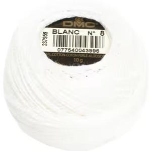 May include: A white ball of DMC Blanc cotton thread, No. 8, with a label showing the product details. The label includes the DMC logo, the word "BLANC", and a barcode. The thread ball weighs 10 g.