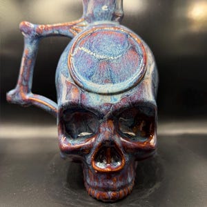 Handmade pottery skull growler