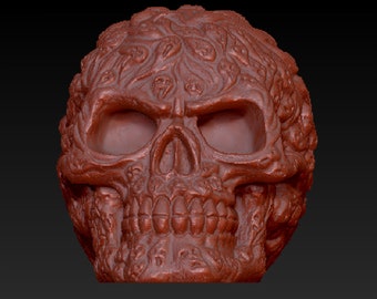 May include: A detailed, red, ceramic skull sculpture with intricate carvings of smaller skulls and floral patterns.