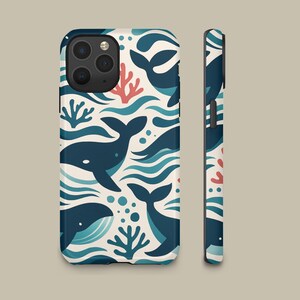 May include: A smartphone case featuring a repeating pattern of dark blue whales, light blue waves, and coral-colored sea plants on an off-white background. The design covers the back and side of the case, showing the camera lens cutout area.