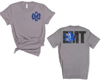 May include: Gray t-shirt with a blue and white medical symbol and the text "EMT" on the front. The back of the shirt has the text "EMT" with a distressed black background and a blue and white medical symbol.