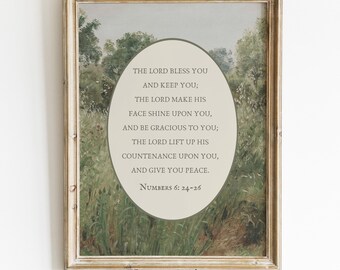 May include: A framed wall art print featuring a landscape painting of a green field with trees. An oval overlay in the centre contains the text: THE LORD BLESS YOU AND KEEP YOU; THE LORD MAKE HIS FACE SHINE UPON YOU, AND BE GRACIOUS TO YOU; THE LORD LIFT UP HIS COUNTENANCE UPON YOU, AND GIVE YOU PEACE. NUMBERS 6: 24-26.