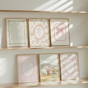 May include: A set of framed art prints with floral and gingham patterns. The prints feature inspirational quotes and verses in elegant fonts, with soft pink and cream colour schemes. The frames are a light wood colour.