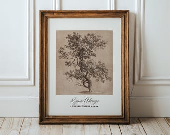 Puede incluir: Una lámina de arte enmarcada con una ilustración detallada en tinta marrón de un árbol sobre un fondo beige claro. Debajo del árbol, el texto "Rejoice Always" aparece en letra cursiva, seguido de "1 THESSALONIANS 5:16-18" en letra serif.