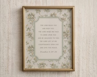 May include: A framed print with a gold-colored frame. The print features a floral patterned background and a central text block with a religious quote. The text reads "The Lord bless you and keep you...Numbers 6:24-26."
