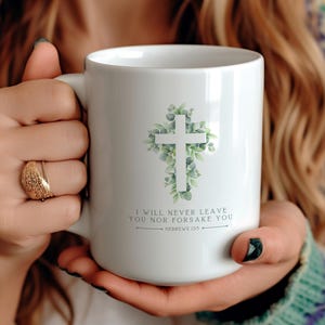 May include: White ceramic mug with a green leafy cross design and the text "I will never leave you nor forsake you - Hebrews 13:5".