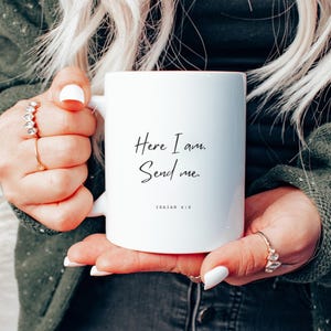 May include: White ceramic mug with black text that reads "Here I am. Send me. Isaiah 6:8".