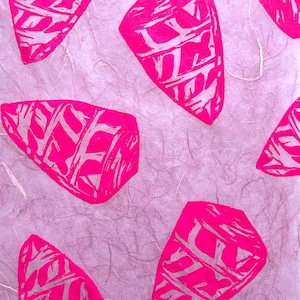May include: A pattern of bright pink, abstract shapes with white linework, printed on a textured, light purple background. The shapes are irregularly shaped with a geometric design. The overall effect is a bold, graphic design.