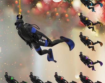 May include: A set of ten Christmas ornaments featuring a scuba diver in various colors. Each ornament is a silhouette of a diver with a tank, fins, and a mask. The diver is wearing a wetsuit and has the word "ATLAS" printed on the leg. The ornaments are perfect for a nautical themed Christmas tree.