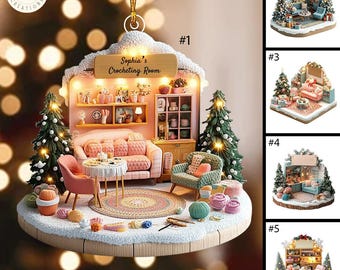May include: A miniature crocheting room ornament with a pink couch, a table with chairs, and a Christmas tree. The ornament is decorated with yarn balls and a crocheted rug. The ornament is labeled "Sophia's Crocheting Room".