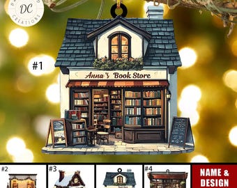 May include: A decorative ornament shaped like a miniature bookstore, featuring a detailed facade with a sign that reads "Anna's Book Store." The ornament has a black roof, a red awning, and is filled with tiny books. A gold string is attached for hanging.