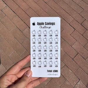 May include: A white card with the text "Apple Savings Challenge" and apple illustrations. The card has a grid of apple icons with the value "$20" beneath each. The total savings amount is $500.