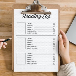 May include: A white clipboard with a black and white reading log template. The template has spaces to fill in the title, author, genre, length, date started, and date finished of a book. There are five stars next to each entry.