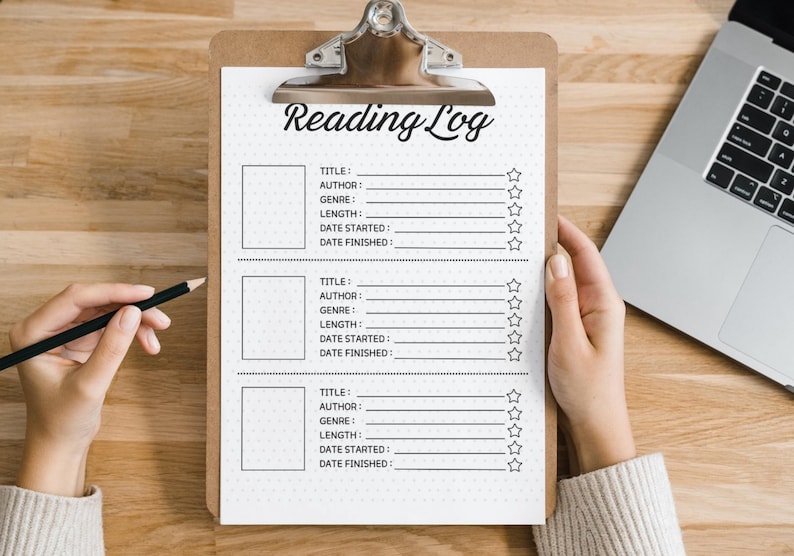 May include: A white clipboard with a black and white reading log template. The template has spaces to fill in the title, author, genre, length, date started, and date finished of a book. There are five stars next to each entry.