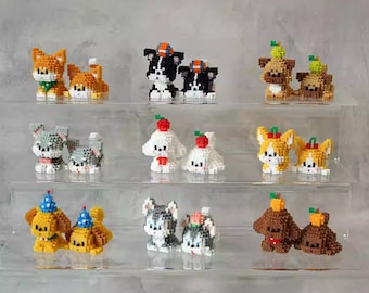 May include: A collection of 10 pairs of small, colorful, pixelated animal figurines. The figurines are arranged on three clear acrylic shelves. The figurines include dogs, cats, and other animals.