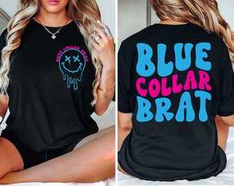May include: Black t-shirt with a blue dripping smiley face on the front and the text "BLUE COLLAR BRAT" in blue and pink letters on the back.
