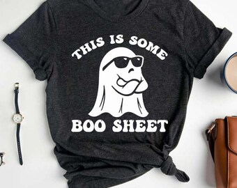 May include: A dark gray t-shirt with a white ghost wearing sunglasses and the text "This is some boo sheet".