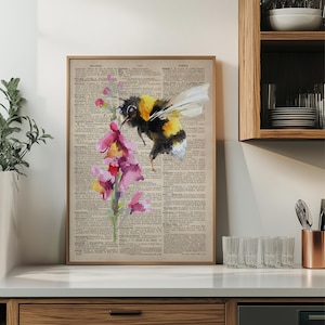 May include: A watercolor painting of a bumblebee pollinating a pink flower. The painting is on a vintage dictionary page with the word "wildlife" highlighted.