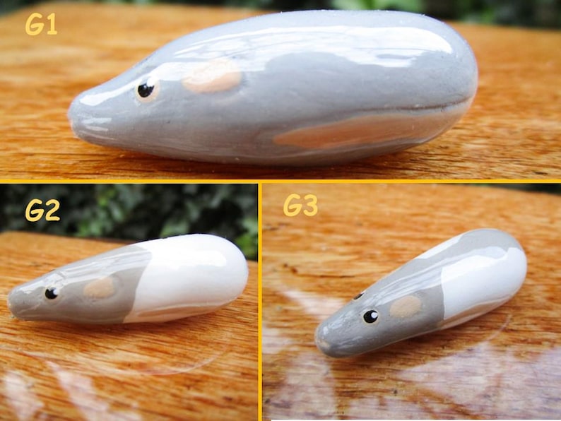 May include: Three ceramic mouse figurines, each with a different color pattern. The first mouse is gray with a light pink belly, the second mouse is gray and white, and the third mouse is gray and white with a light pink belly.