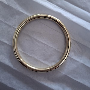 Peut inclure: Un anneau en métal doré, probablement pour une poignée de sac ou de sac à main.