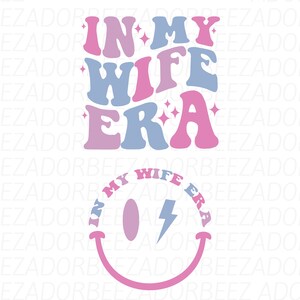May include: Pink and blue graphic with the text "In My Wife Era" in a retro font style. Below the text is a pink smiley face with a blue lightning bolt inside.