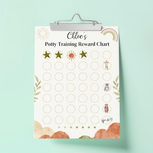 May include: A clipboard with a printed potty training reward chart. The chart is beige with a sun, rainbow, stars, and animal illustrations. The text "Chloe's Potty Training Reward Chart" is at the top, with the words "You did it!" at the bottom.