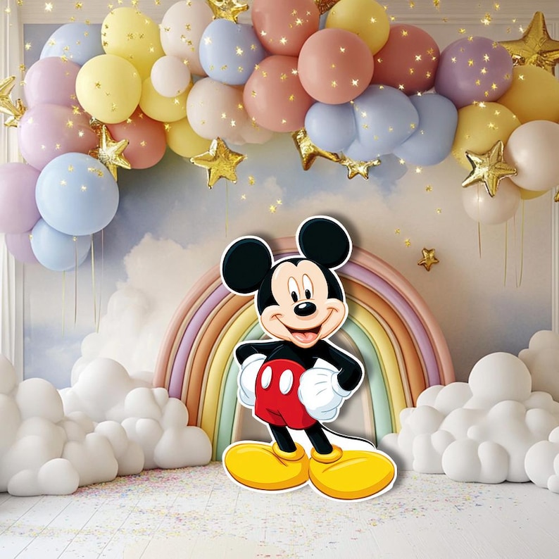 May include: A colorful party backdrop featuring a Mickey Mouse cutout in front of a rainbow and cloud decorations. Pastel-colored balloons and gold star accents create a festive atmosphere, perfect for a birthday celebration.