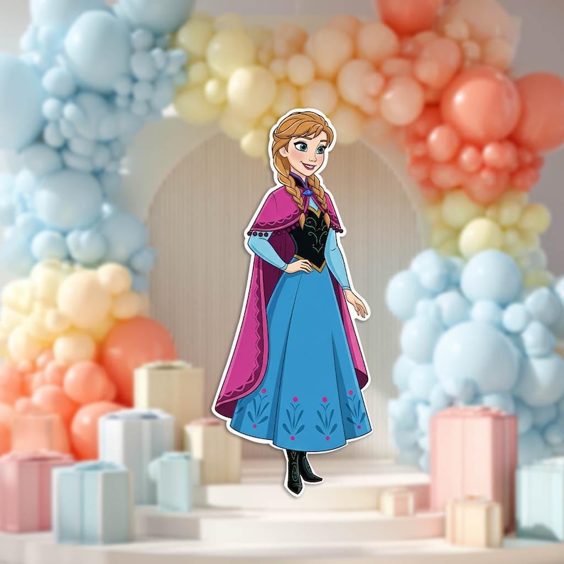 May include: A cut-out of a cartoon character, Anna from Frozen, wearing a blue dress with a pink cape. The background features a balloon arch in pastel colors and decorative gift boxes.