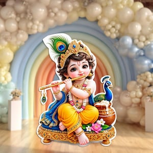 May include: A decorative cutout of a young child with dark hair, wearing a gold crown with a peacock feather, playing a gold flute. The figure wears yellow pants, a blue shawl, and gold jewelry, sitting on an ornate gold base with a peacock and a pot.