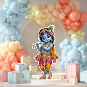 May include: A cutout illustration of a blue-skinned deity playing a golden flute, wearing a vibrant, multi-colored traditional outfit with intricate patterns, a peacock feather in the hair, and ornate gold jewelry, standing against a pastel balloon arch.