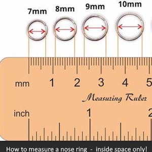 May include: Four silver-toned circular nose rings arranged in a row above a wooden ruler. The rings are labeled 7mm, 8mm, 9mm, and 10mm, with red arrows indicating the inside diameter. The ruler shows both millimeter and inch markings.