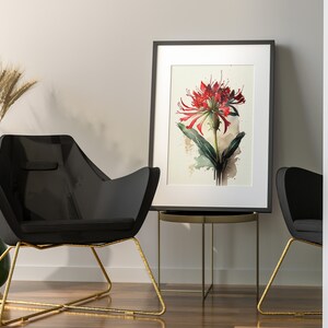 Puede incluir: Una pintura al agua enmarcada de una flor roja con hojas verdes sobre un fondo blanco. La pintura est&aacute; colgada en una pared blanca sobre una silla negra con patas doradas.