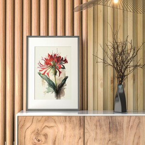 Puede incluir: Una impresi&oacute;n enmarcada de una flor roja con hojas verdes sobre un fondo blanco. La impresi&oacute;n est&aacute; colgada en una pared con paneles de madera. Un jarr&oacute;n negro con una rama seca est&aacute; sobre un gabinete de madera con dos cajones.
