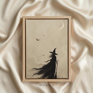 May include: A framed wall art print featuring a silhouette of a figure in a pointed hat and long flowing cloak holding a broomstick. The scene is set against a beige background with a crescent moon and small flying bats in the sky above.