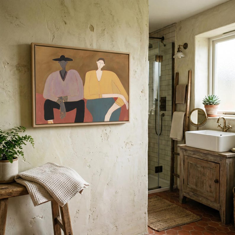 May include: A rectangular framed wall art piece featuring a stylized painting of two figures. One figure wears a light purple top and dark pants, while the other wears a yellow top and blue pants, set against a solid brown and red background.