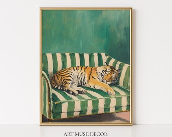 May include: A framed art print featuring a sleeping tiger on a green and white striped sofa. The artwork has a gold frame and a green background. The text "ART MUSE DECOR" and "Frame for visual purposes ONLY" are at the bottom.