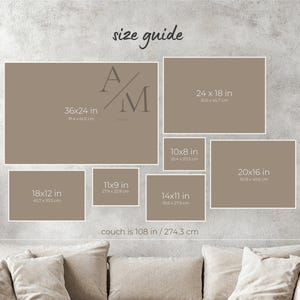 The image is a wall display featuring a series of framed artworks or photographs arranged in a grid pattern. The sizes of the frames vary, ranging from 36x24 in one frame to 14x16 in another. The couch is positioned below the display, and the image includes text that provides the dimensions of the frames in centimeters.