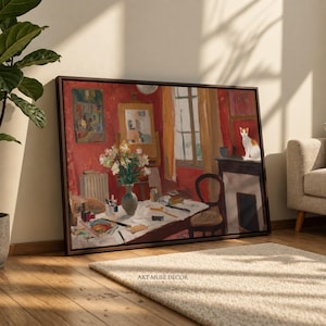 May include: A framed rectangular canvas print featuring an oil painting of a red-walled studio interior. The scene depicts a white table with a vase of flowers, art supplies, a chair, a window with yellow curtains, and a white cat on a mantel.