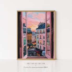 May include: A framed art print showing a cityscape through an open window. The painting features buildings in pink, yellow, and blue hues beneath a sunset sky. The frame is gold, and the text "ART MUSE DECOR" is at the bottom.