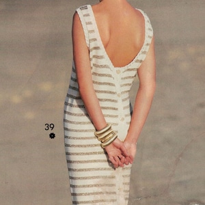 May include: A white and gold striped sleeveless dress with a low back and a button closure. The dress is fitted and has a straight skirt.