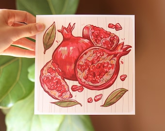 May include: A hand-drawn illustration of pomegranates on a light pink background. The pomegranates are red and have a white interior. The illustration is surrounded by green leaves.