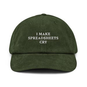 May include: Olive green corduroy baseball cap with the embroidered text "I MAKE SPREADSHEETS CRY" in white. The cap has a curved brim and a structured crown.