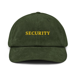 May include: A green corduroy baseball cap with the word "SECURITY" embroidered in yellow.