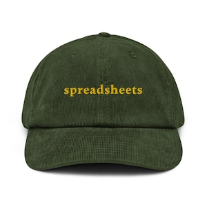 May include: A dark green corduroy baseball cap with the word "spreadsheets" embroidered in yellow.