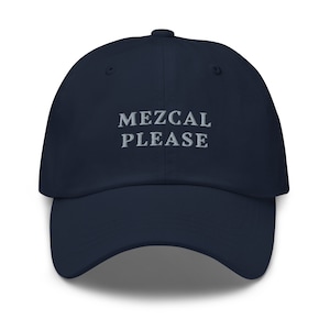 May include: A navy blue baseball cap with the text "MEZCAL PLEASE" embroidered in white on the front.
