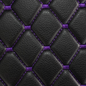 May include: Black leather upholstery with a diamond pattern and purple stitching.