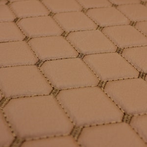 Automotive-grade quilted vinyl fabric with foam backing.
