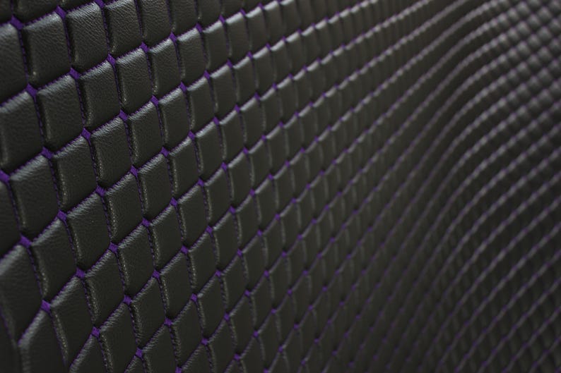 May include: Black leather upholstery with a diamond pattern stitched in purple thread.